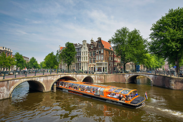 orange canal boats Amsterdam scaled