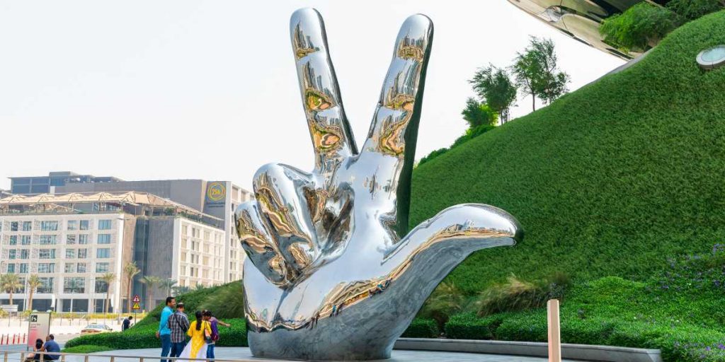 Three Finger Salute Hand Sign and Museum of the Future in Dubai