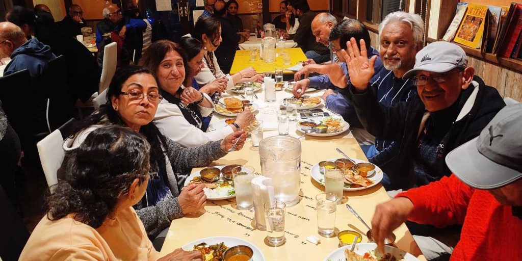 Family Enjoying Indian Food On Tour